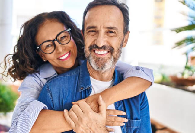 smiling middle-aged coupled in affectionate pose