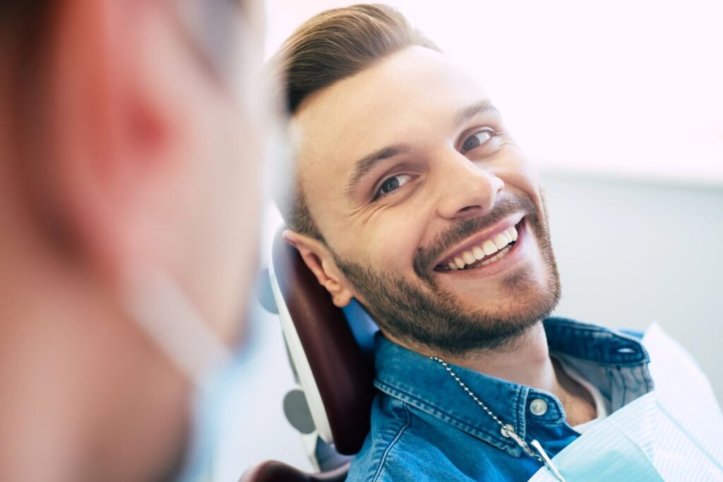 A man smiling in a dentist's chair.